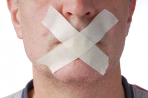 Portrait of man with mouth covered with tape