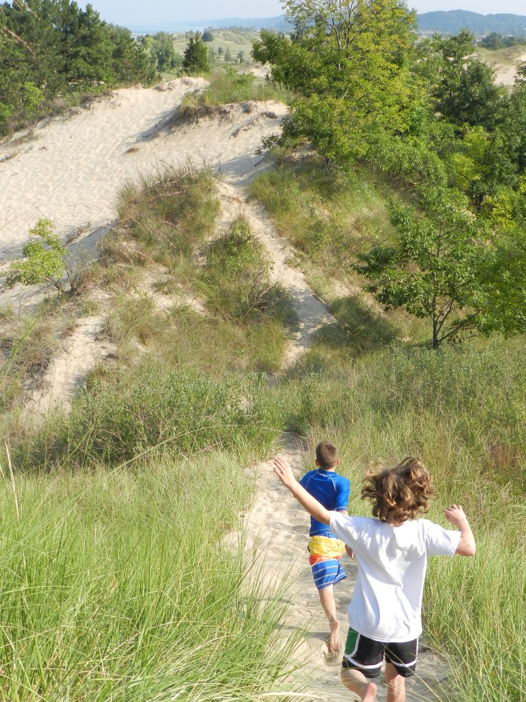 children running down the dunes of Lake Michigan