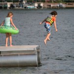 kids jumping off dock into lake — The People Equation