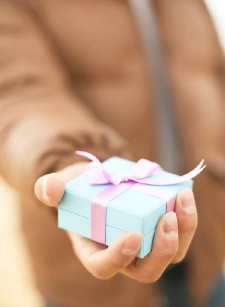 Hand giving a wrapped gift
