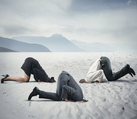 business people head in sand
